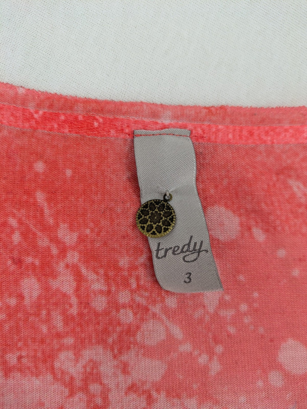 TREDY pink graphic top with rose and wings design, embellished with rhinestones.