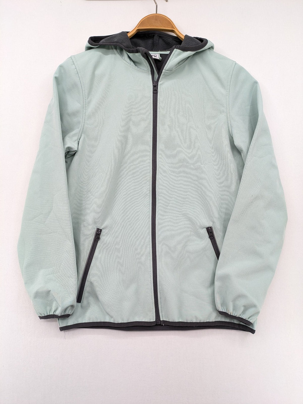 YFK outdoor jacket mint green softshell with dark grey fleece lining and hood.