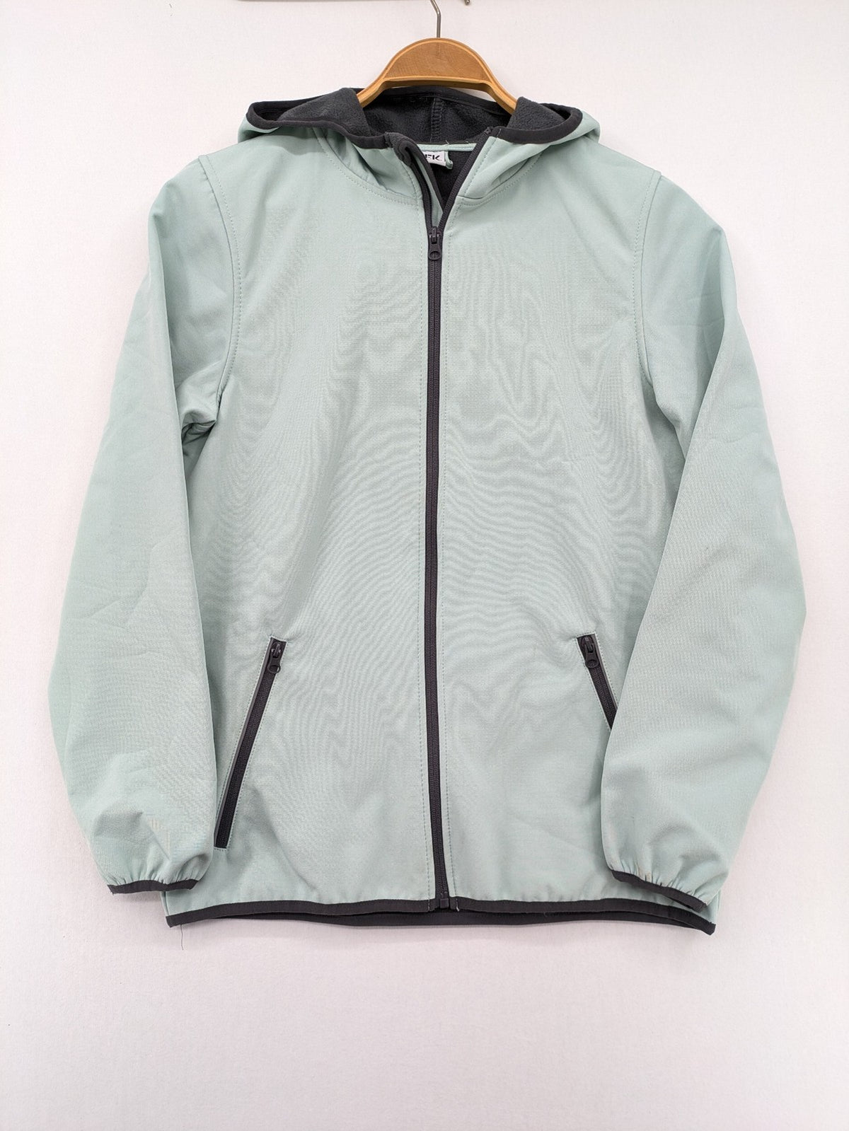 YFK outdoor jacket mint green softshell with dark grey fleece lining and hood.