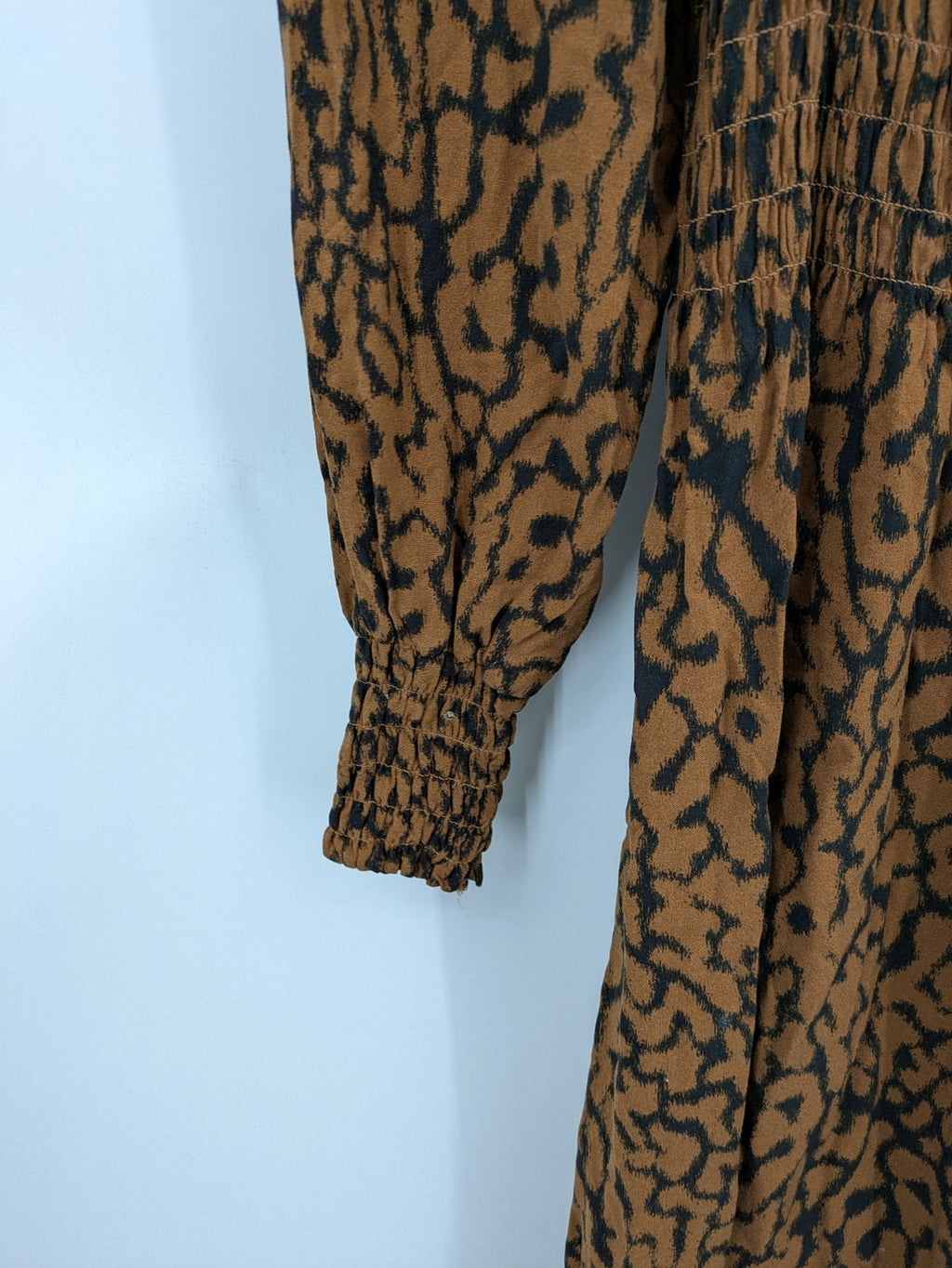 H&M brown and black animal print midi dress with smocked bodice and square neckline.
