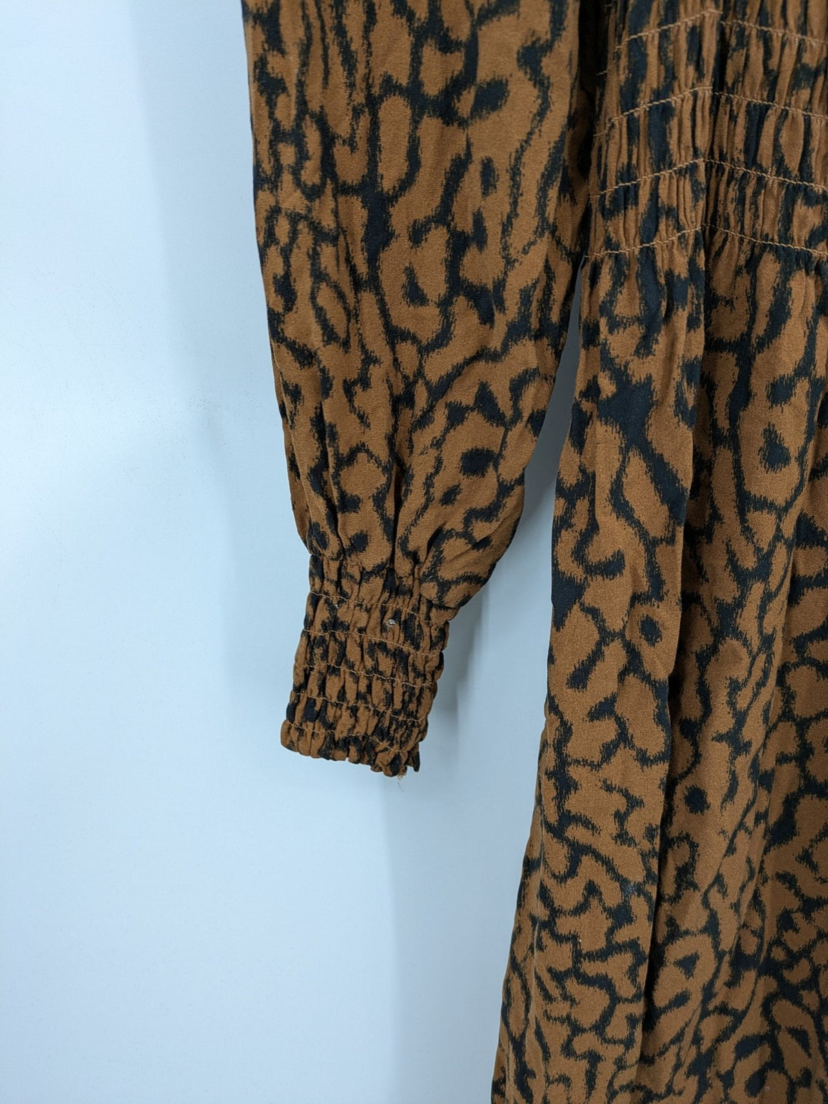 H&M brown and black animal print midi dress with smocked bodice and square neckline.