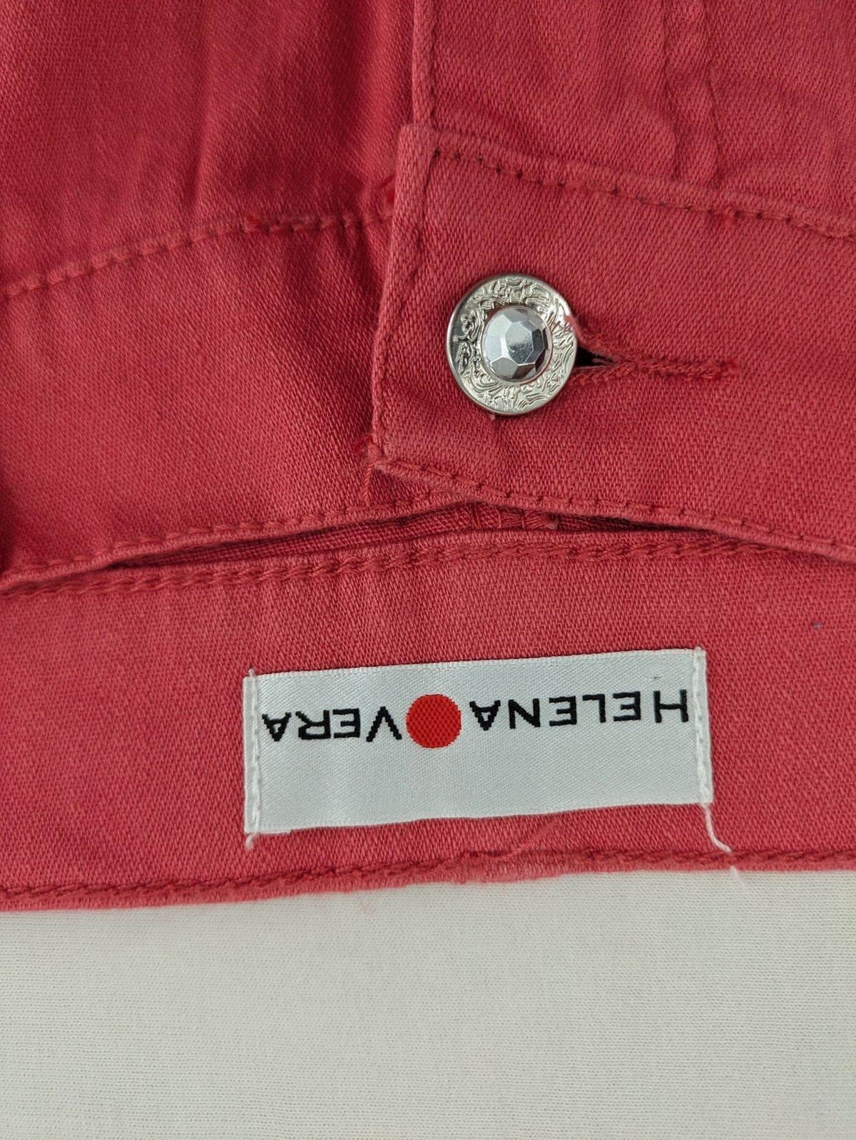 Helena Vera red straight jeans with elastic waistband and rhinestone details on pockets.
