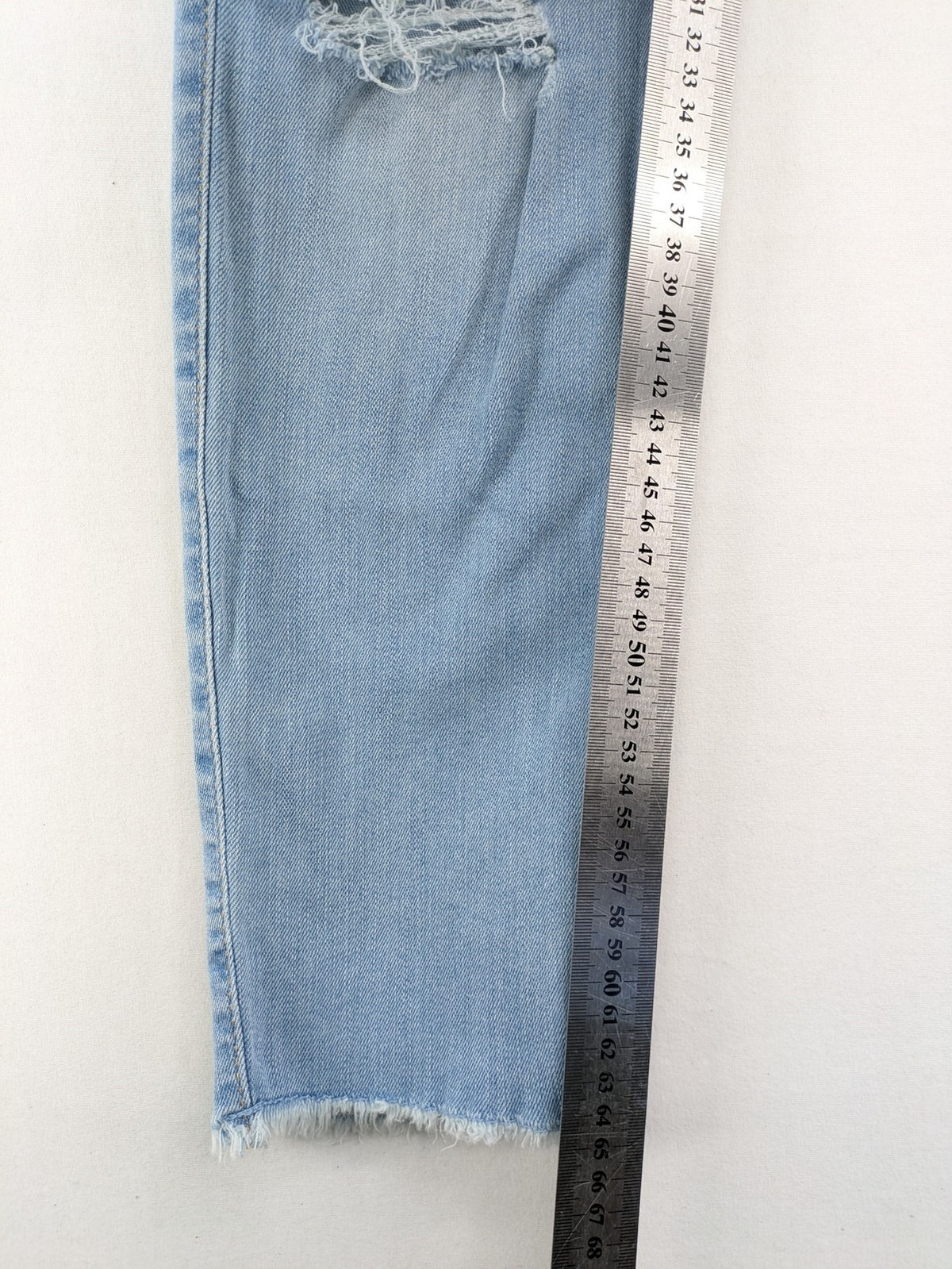 Hollister blue high-rise crop super skinny jeans with distressed rips and frayed hem.
