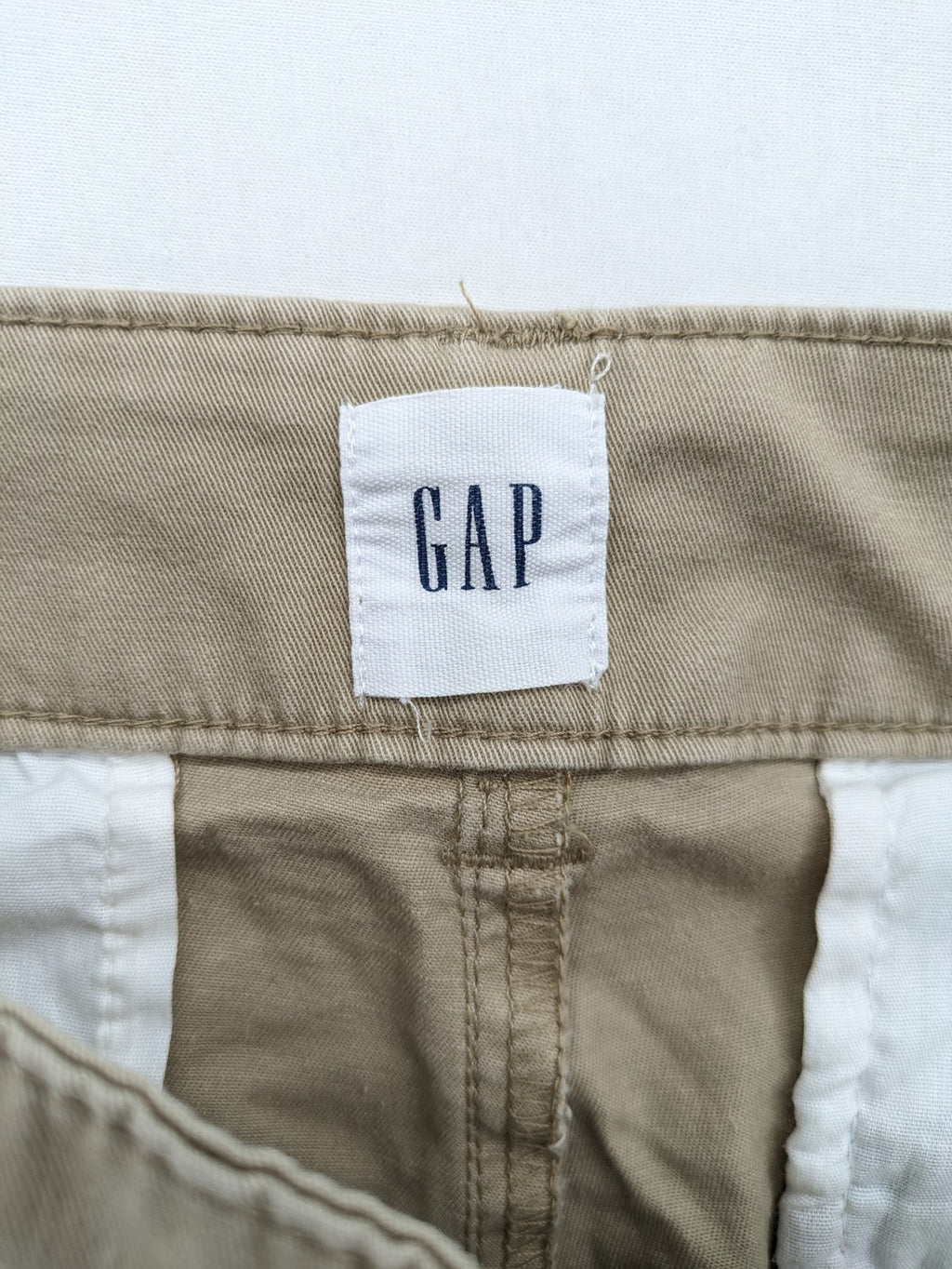 Gap beige girlfriend chino pants with relaxed fit and soft cotton-stretch blend.