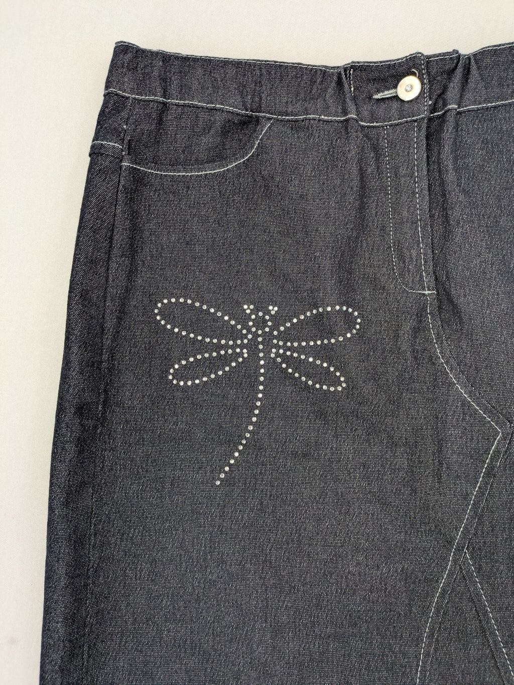 Extyn blue midi skirt with rhinestone dragonfly detail and front slit, stretchy denim fabric.
