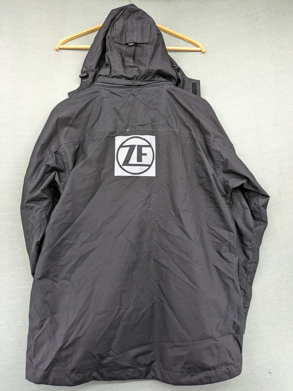 Stormtech black waterproof jacket with ZF logo, H2Xtreme technology, front zipper, and hood.
