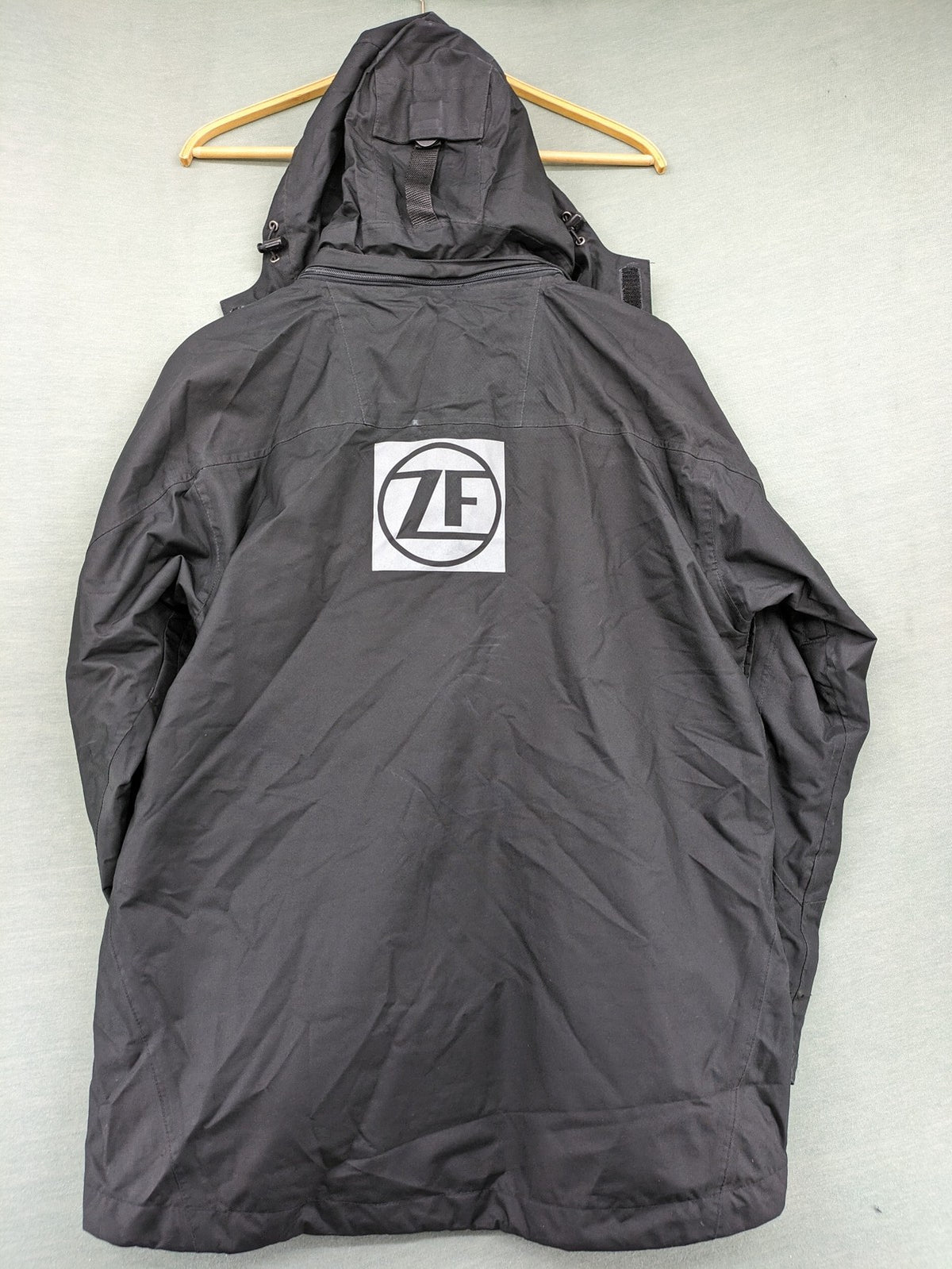 Stormtech black waterproof jacket with ZF logo, H2Xtreme technology, front zipper, and hood.